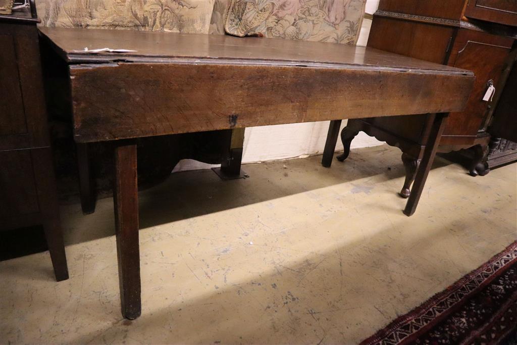 An 18th century provincial oak drop flap dining table, width 155cm, depth 66cm, height 71cm